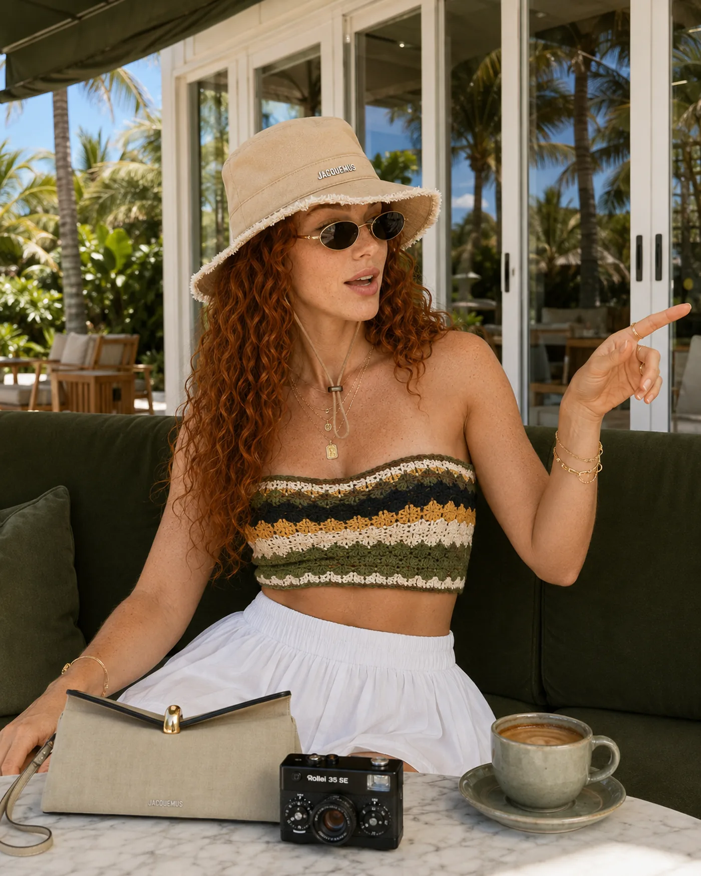 Olivia at a café terrace with hat, bag and camera